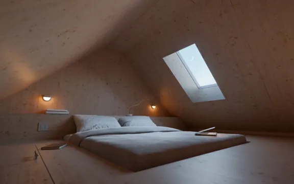 A bed in an attic.